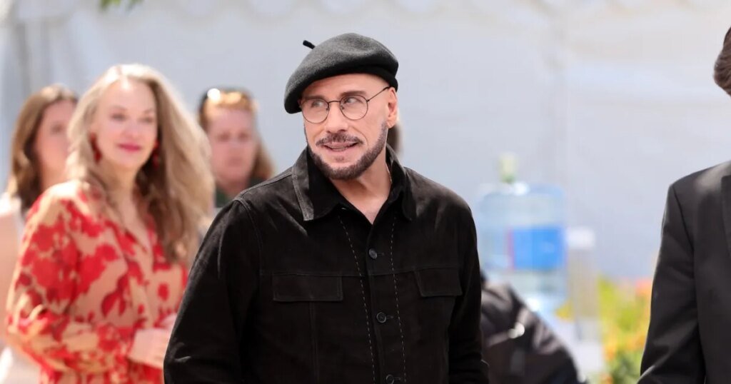 John Travolta's Viral Cannes Look: Beret and Glasses Steal the Show