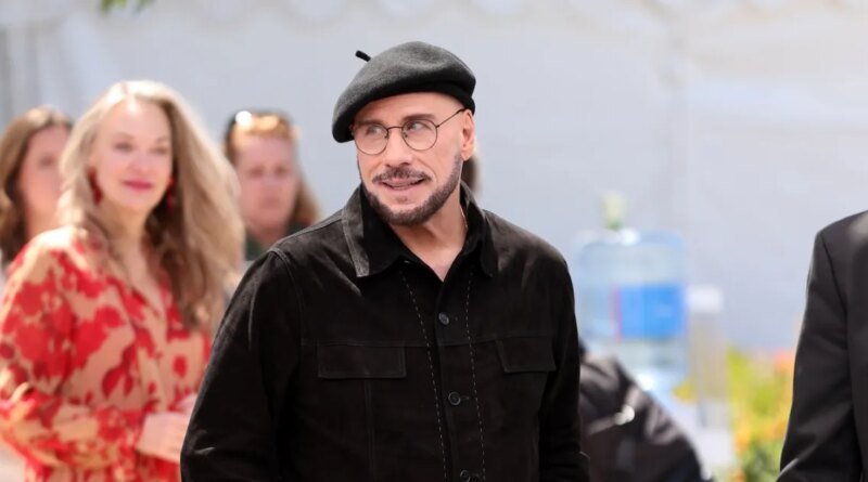 John Travolta's Viral Cannes Look: Beret and Glasses Steal the Show